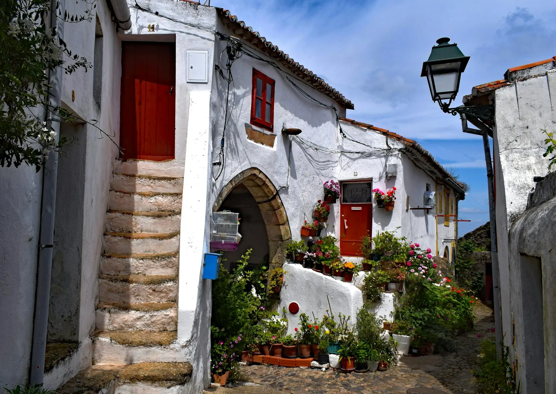 Minimalist white concrete house surrounded by lush greenery in Porto Alegre, Portugal—perfect for sustainable real estate and eco-conscious slow living.