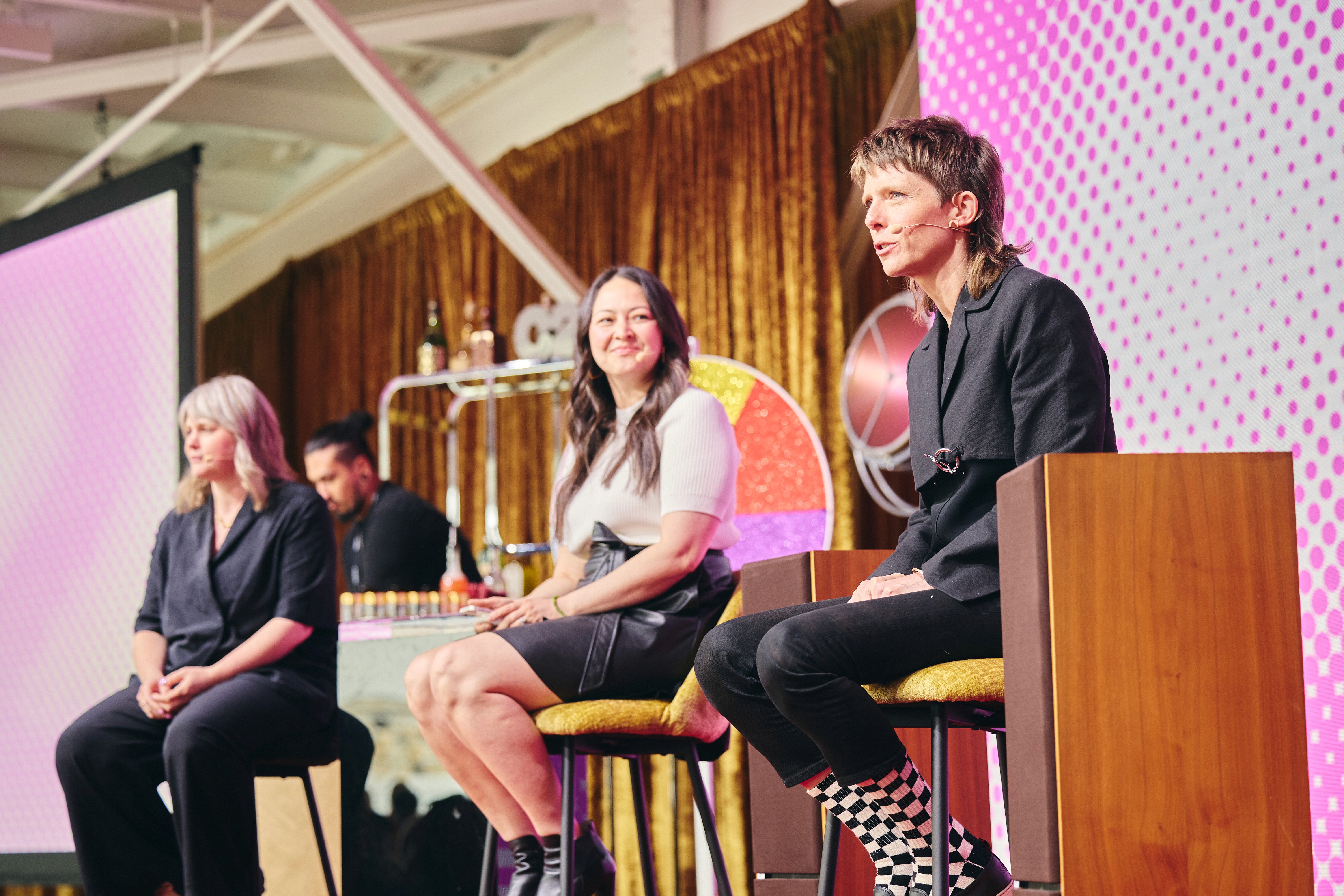 Panel discussion at C2, featuring speakers on stage engaging in a conversation about business, creativity, and innovation.