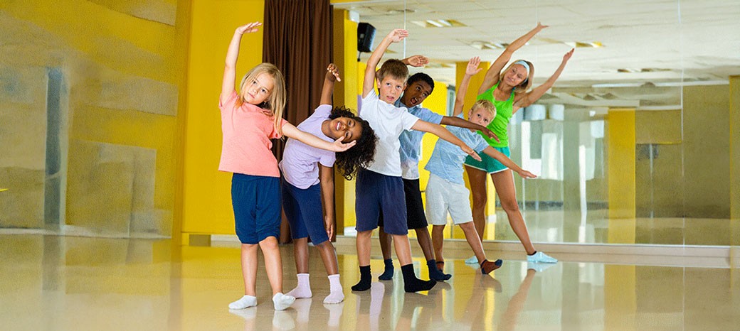 Students practicing classical ballet technique and posture in structured after school dance program