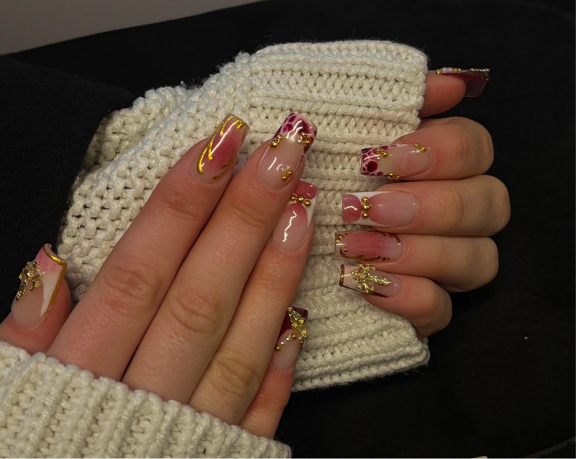 Hand with glittery pastel nails in sunlight