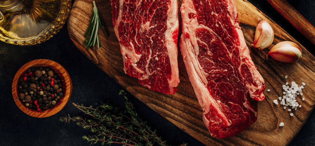 a group of people sitting around a laptop computer