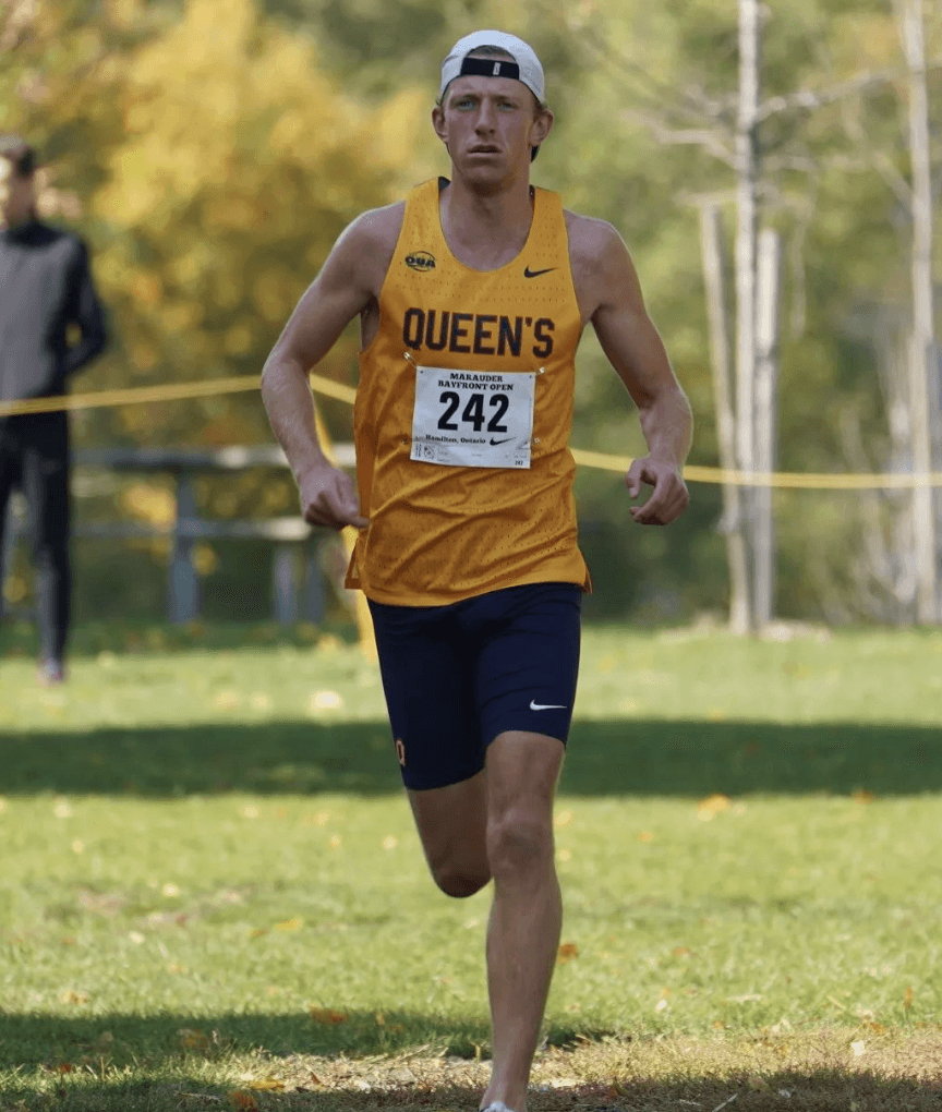 Queen's University runner mid-cross country race