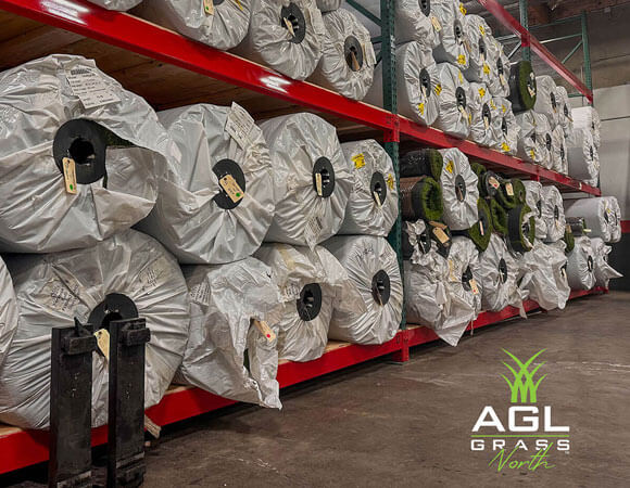 This is a photograph of AGL Grass North's fully stocked warehouse, which offers high-quality artificial grass with fast availability, ensuring a reliable supply for residential, commercial, and sports installations.