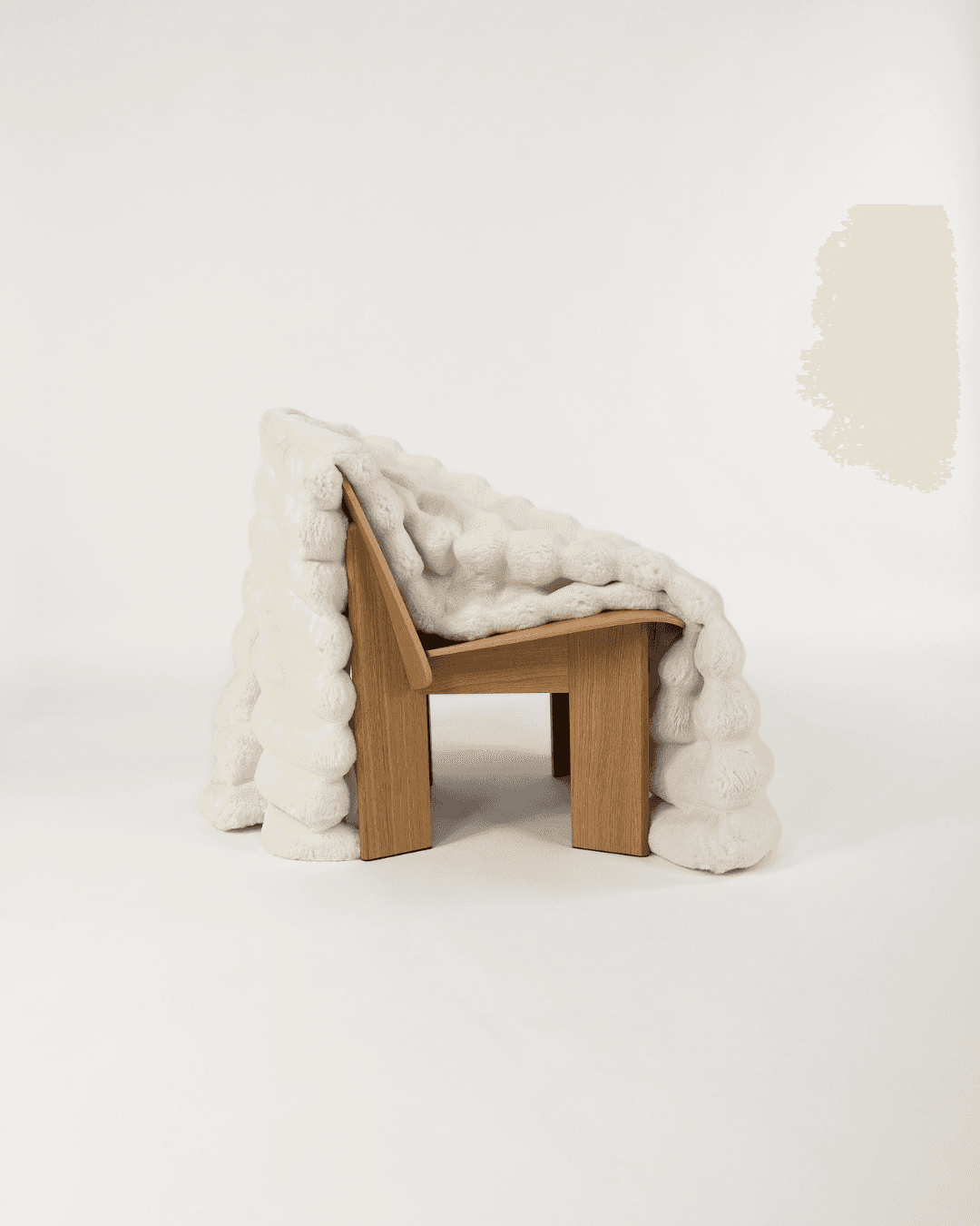 Dimensional faux fur blanket in moon draped on a wooden chair