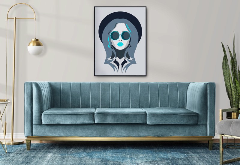 Teal sofa underneath artwork