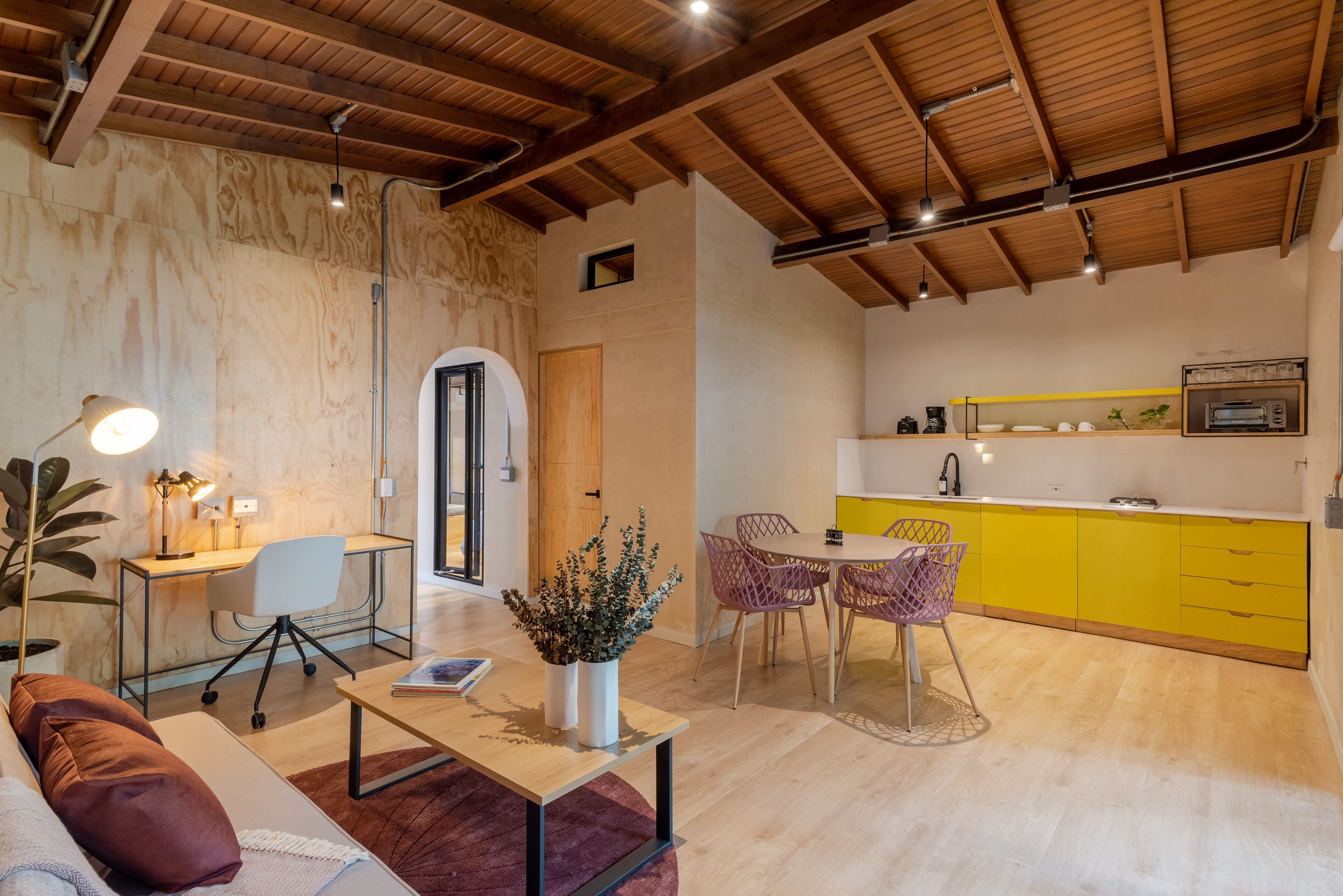 Double-height interior with flowing sculptural forms and warm raking light