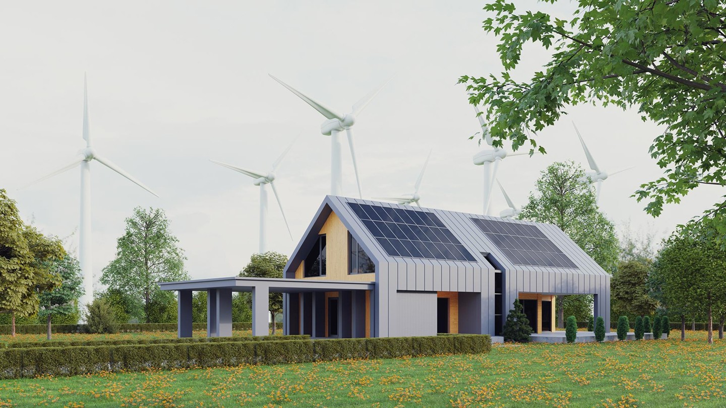 solar panels on the roof and windmills behind it