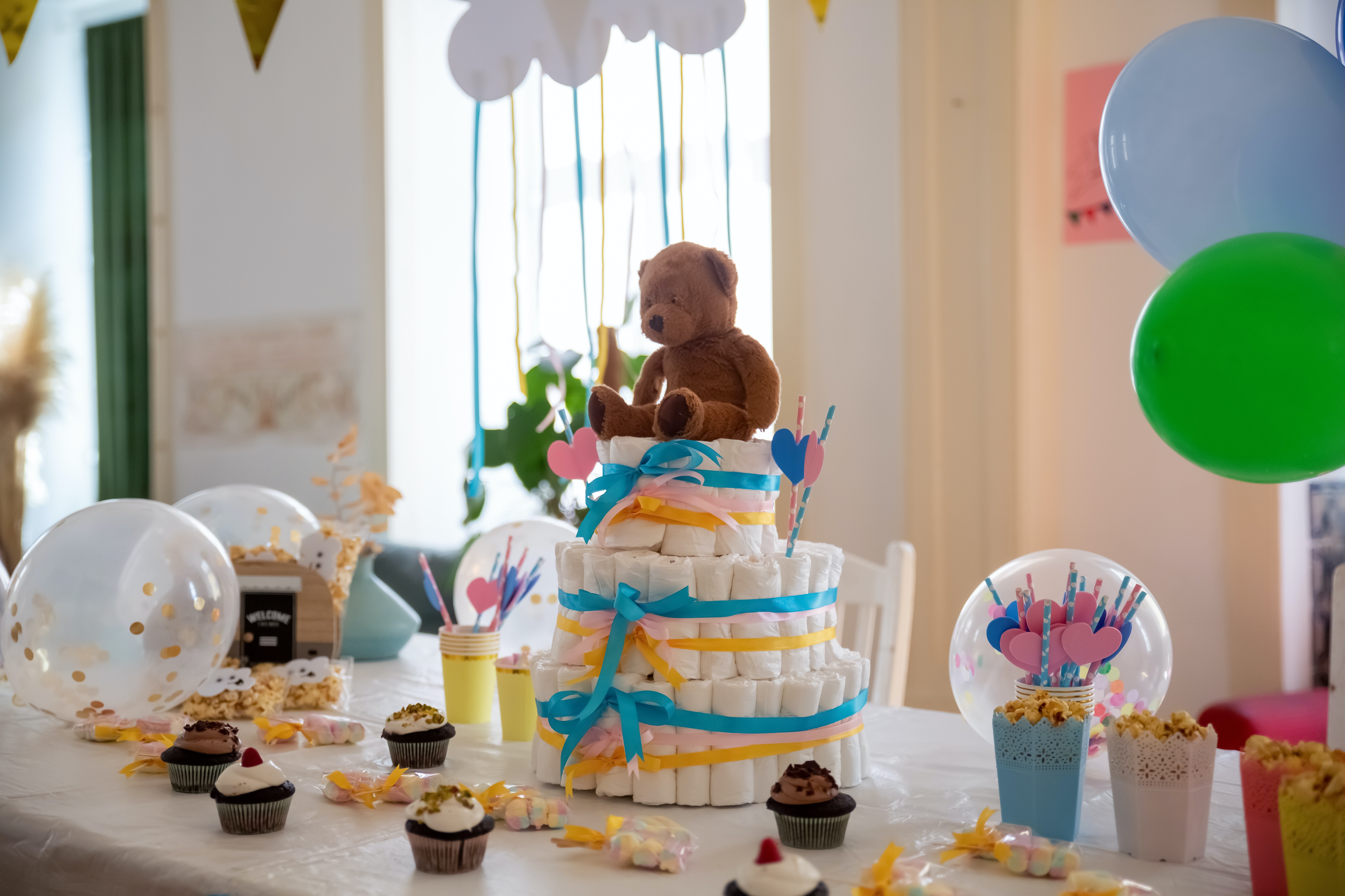 A table decorated with baby shower presents and snacks