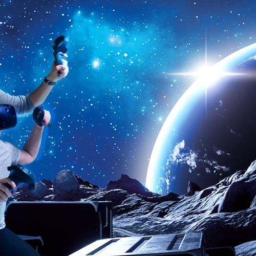Person using VR controllers against a backdrop of a space scene with a planet, stars, and a rocky surface.