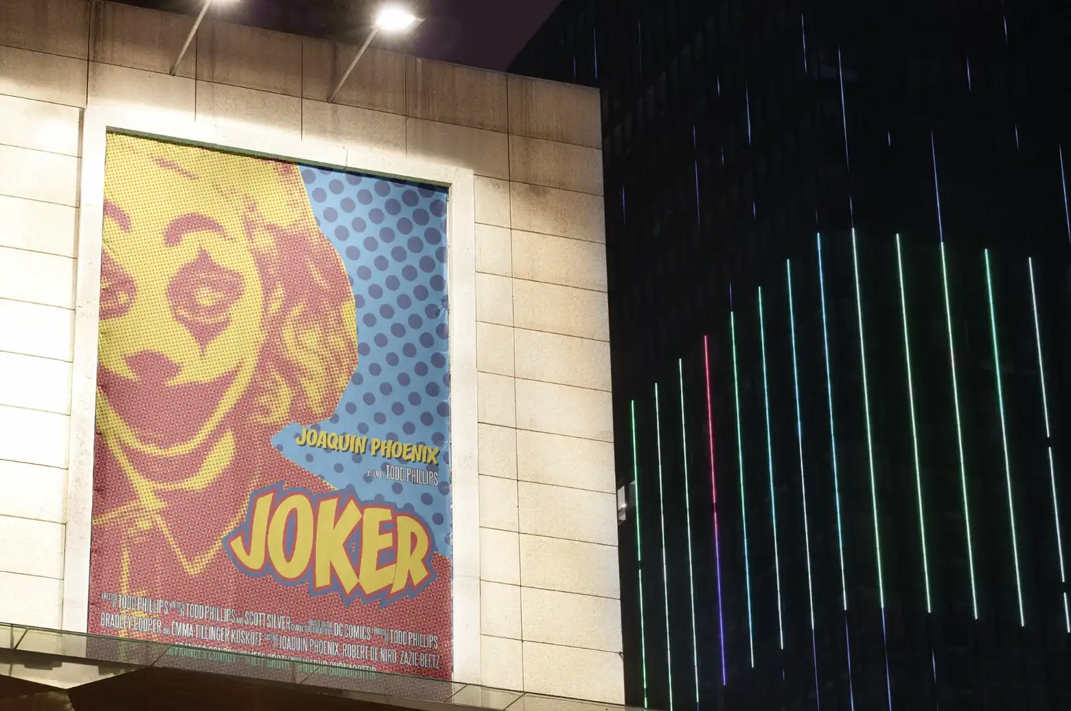 Modern home office setup with a monitor, ergonomic chair, keyboard, and indoor plants near a window with blinds.