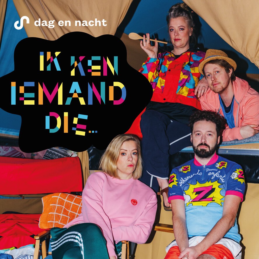 People sitting on pillows in colorful outfits.