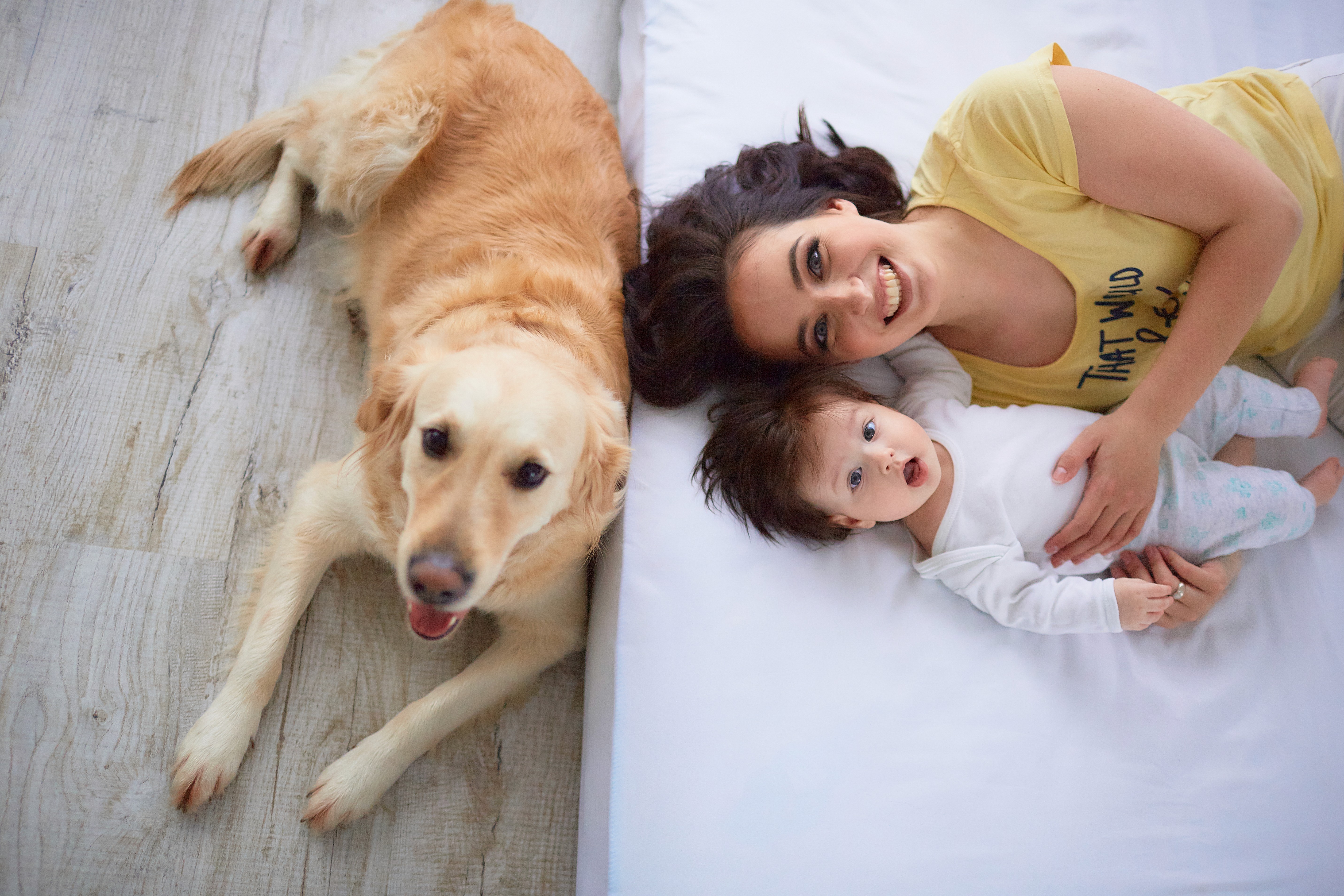 Family relaxing with baby and dog on hybrid flooring in Brisbane, where slip resistance and easy cleaning support safe, everyday living