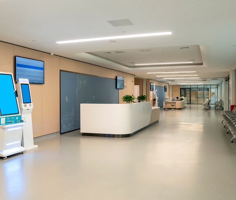 Modern hospital reception area with a white desk
