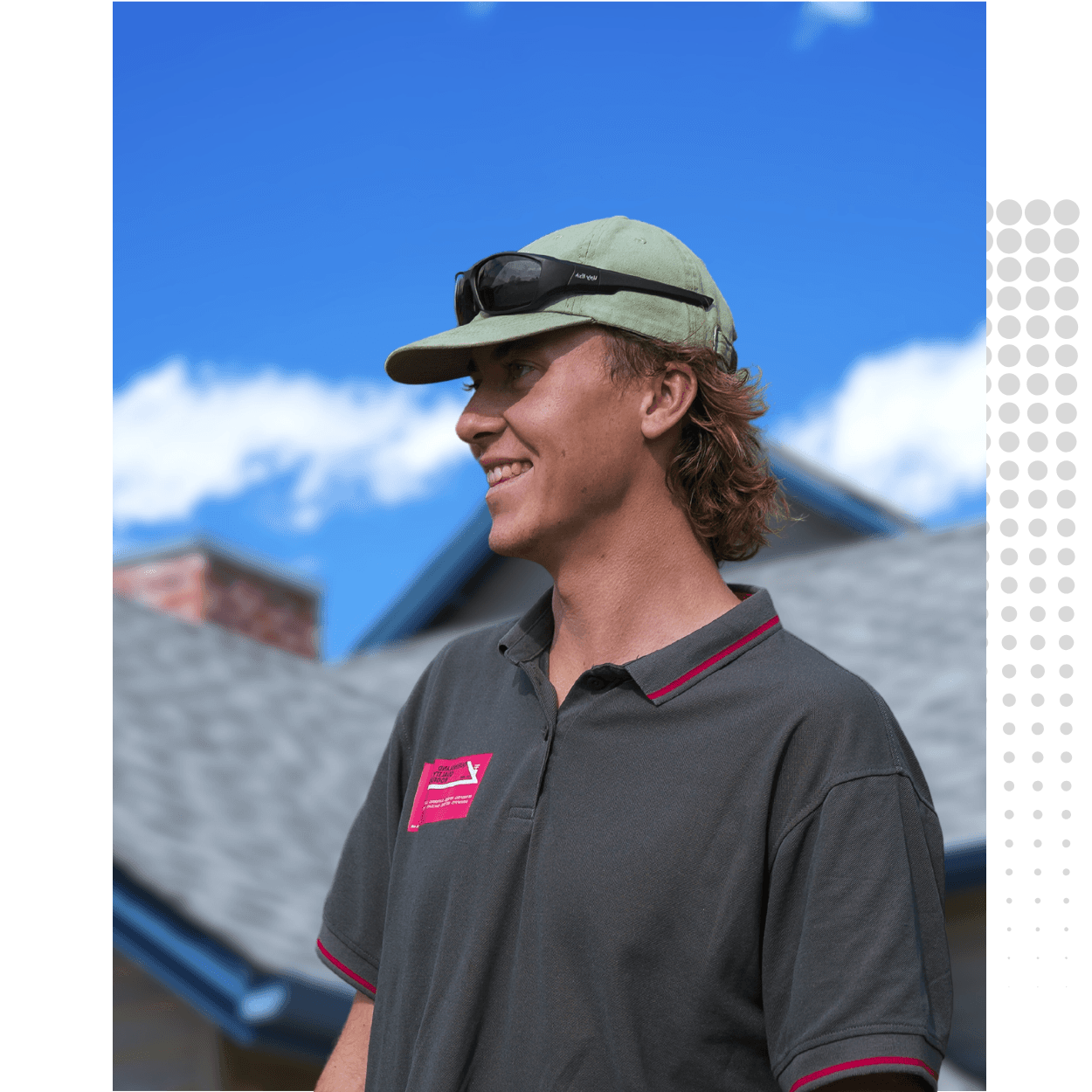 Ricky Javsnik, Founder of Queensland Quality Roofing in Brisbane, smiling while standing outdoors in front of a residential roof under a bright blue sky. A trusted roofing expert dedicated to high-quality craftsmanship and customer service.