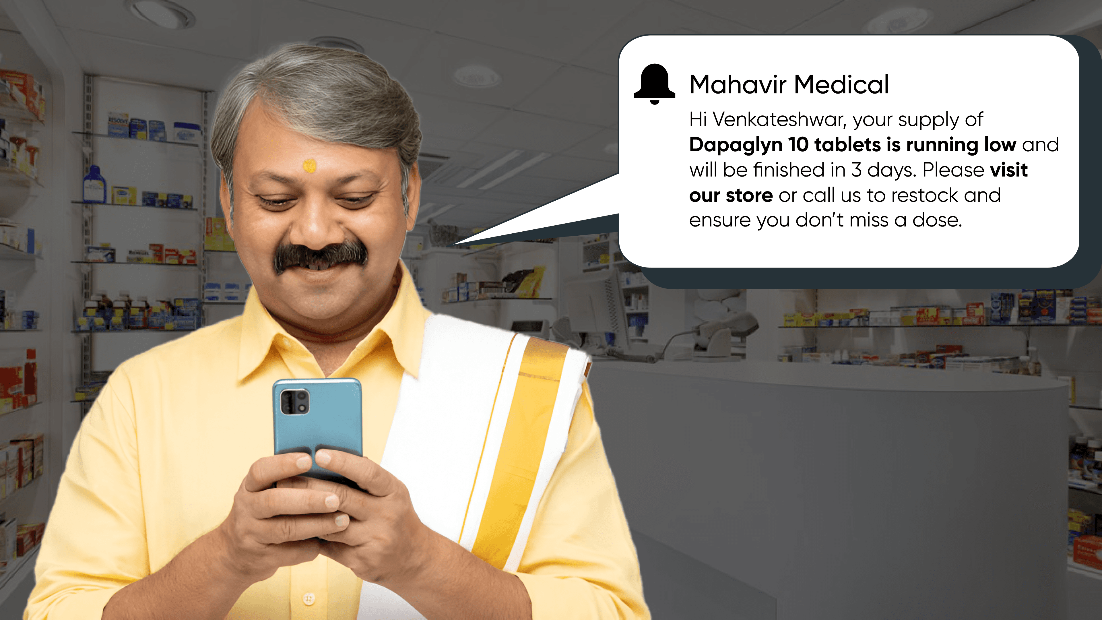 Elderly Indian man receiving pharmacy refill alert via smartphone in local medical store