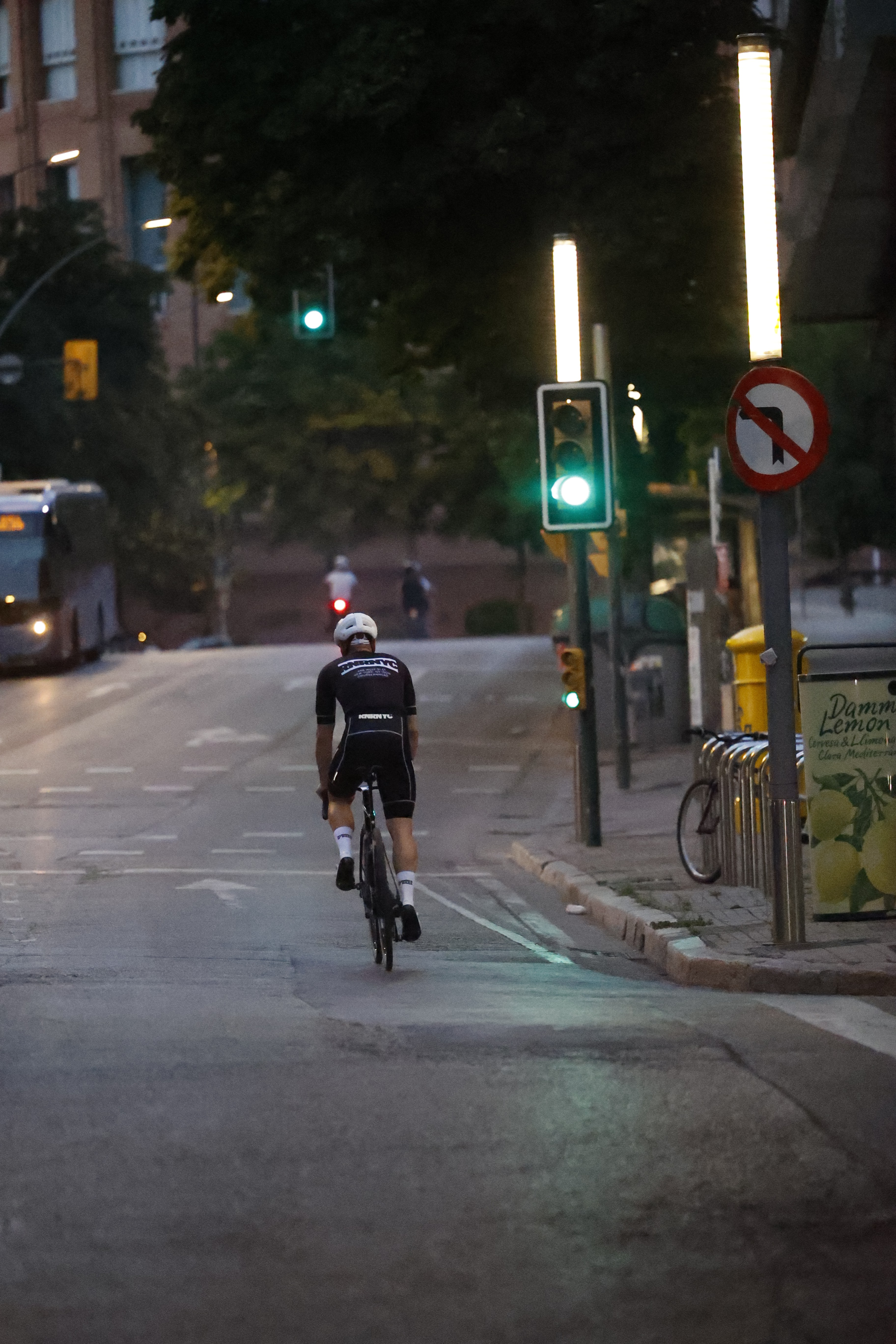 a couple of people riding bikes down a road