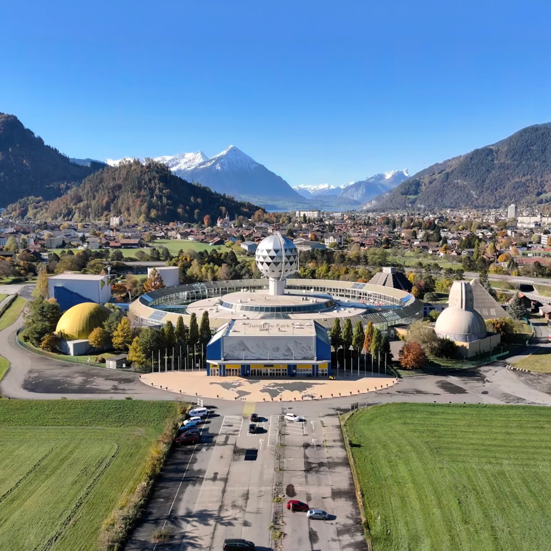 train near trees inside building with indoor waterfalls