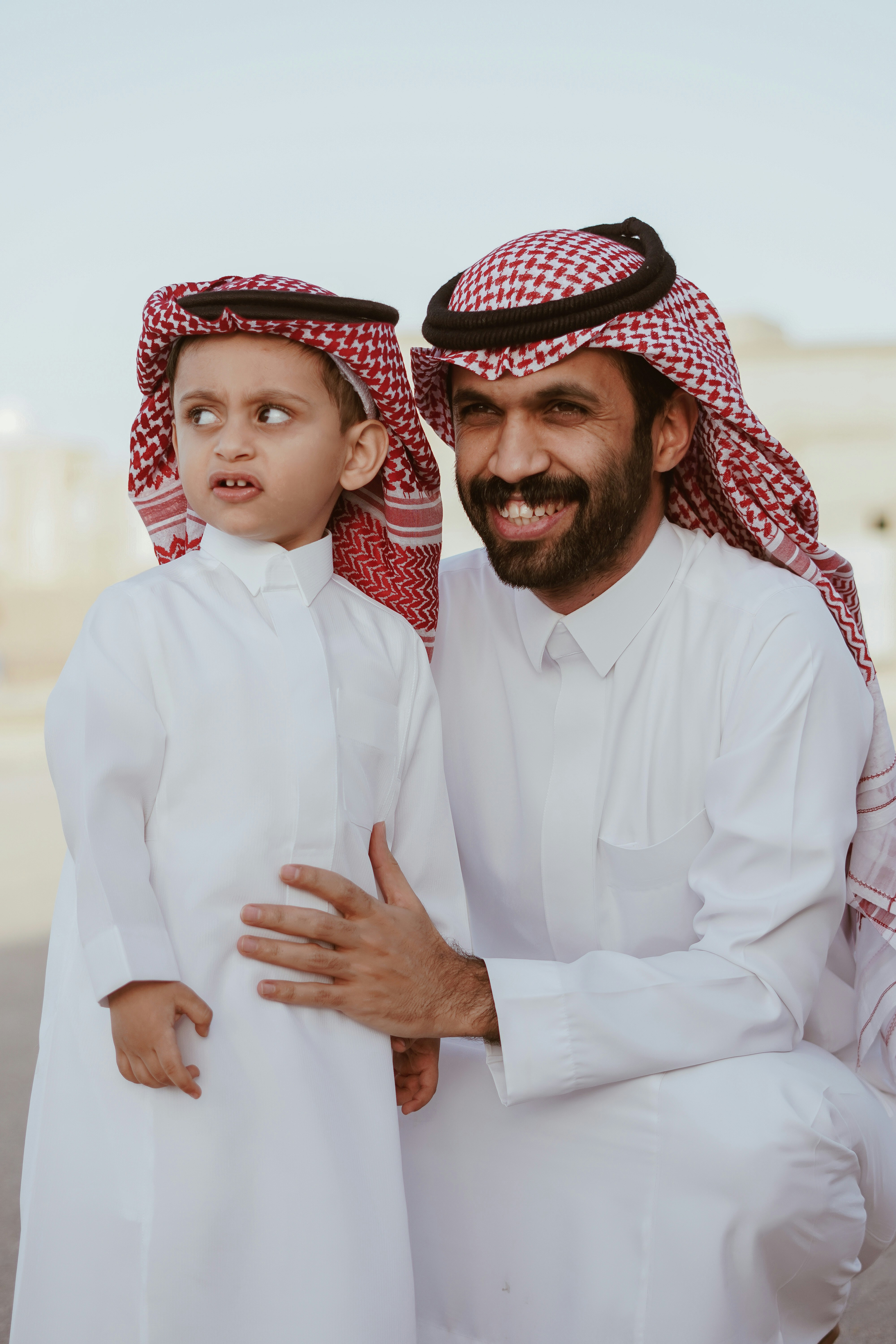 a man and a little boy dressed in traditional clothing