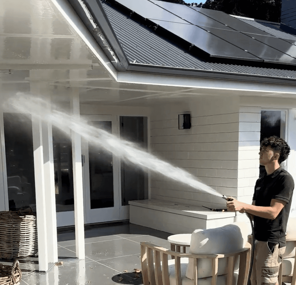 Max cleaning solar panels on a Hamilton home using a water-fed pole system