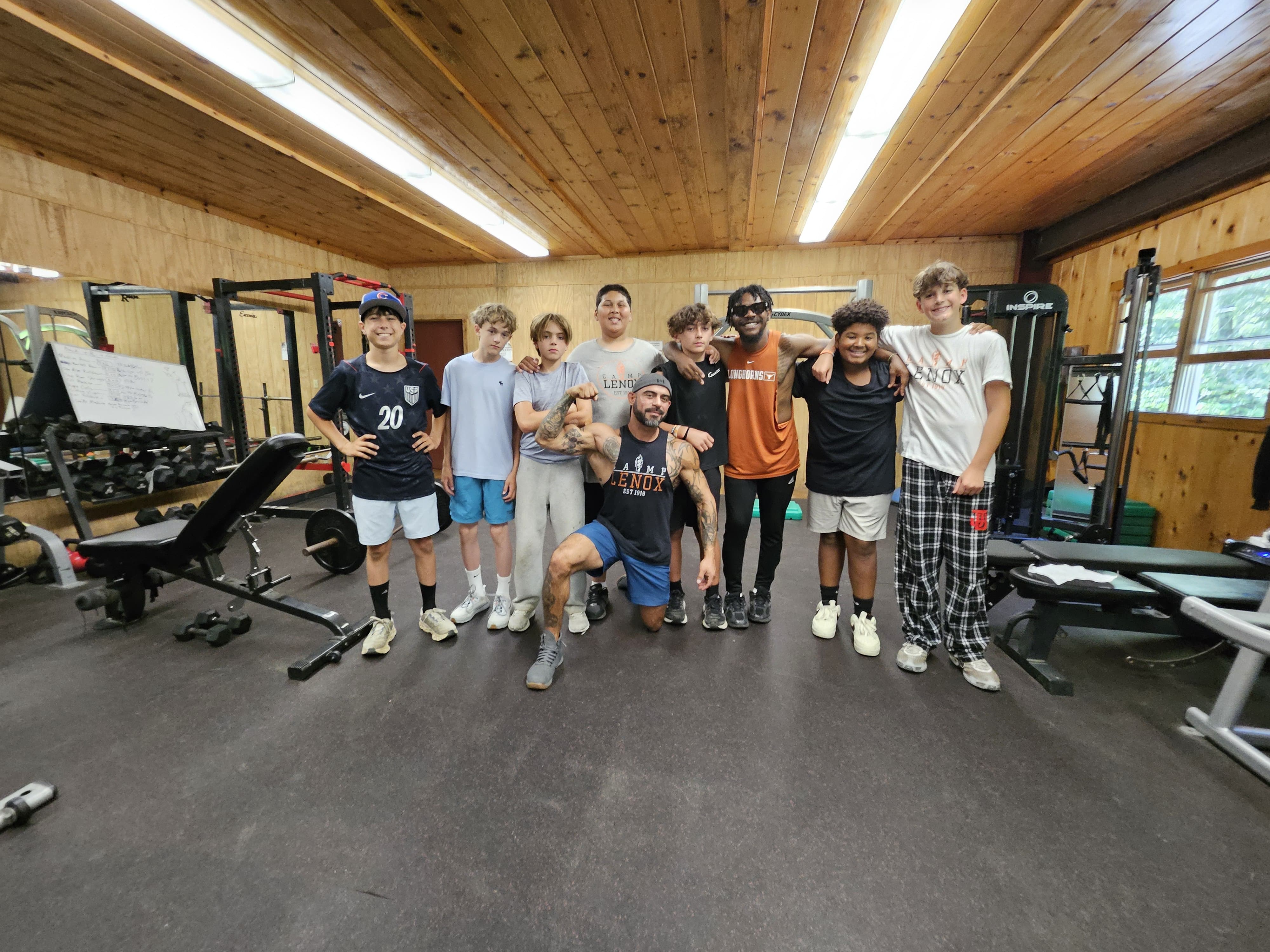 Group of campers and counselors in the Camp Lenox weight room