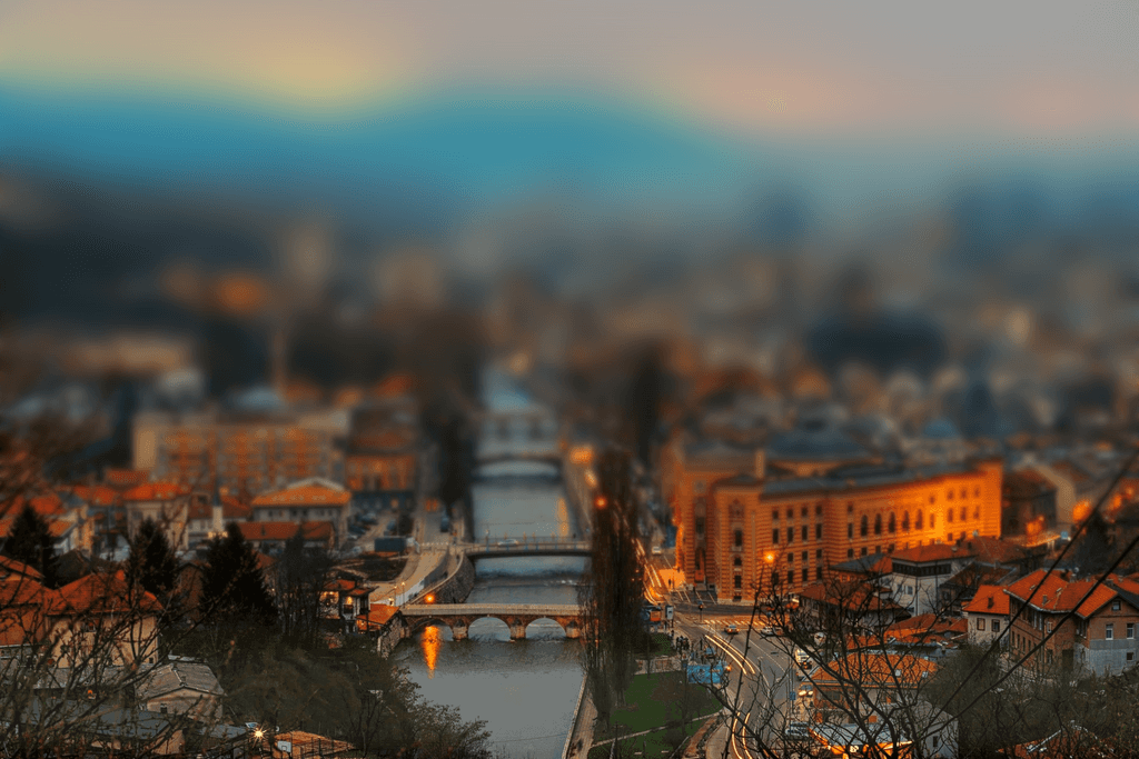 Panoramic daytime view of Sarajevo’s historic skyline with surrounding hills — a popular destination for car rentals in Bosnia and Herzegovina.