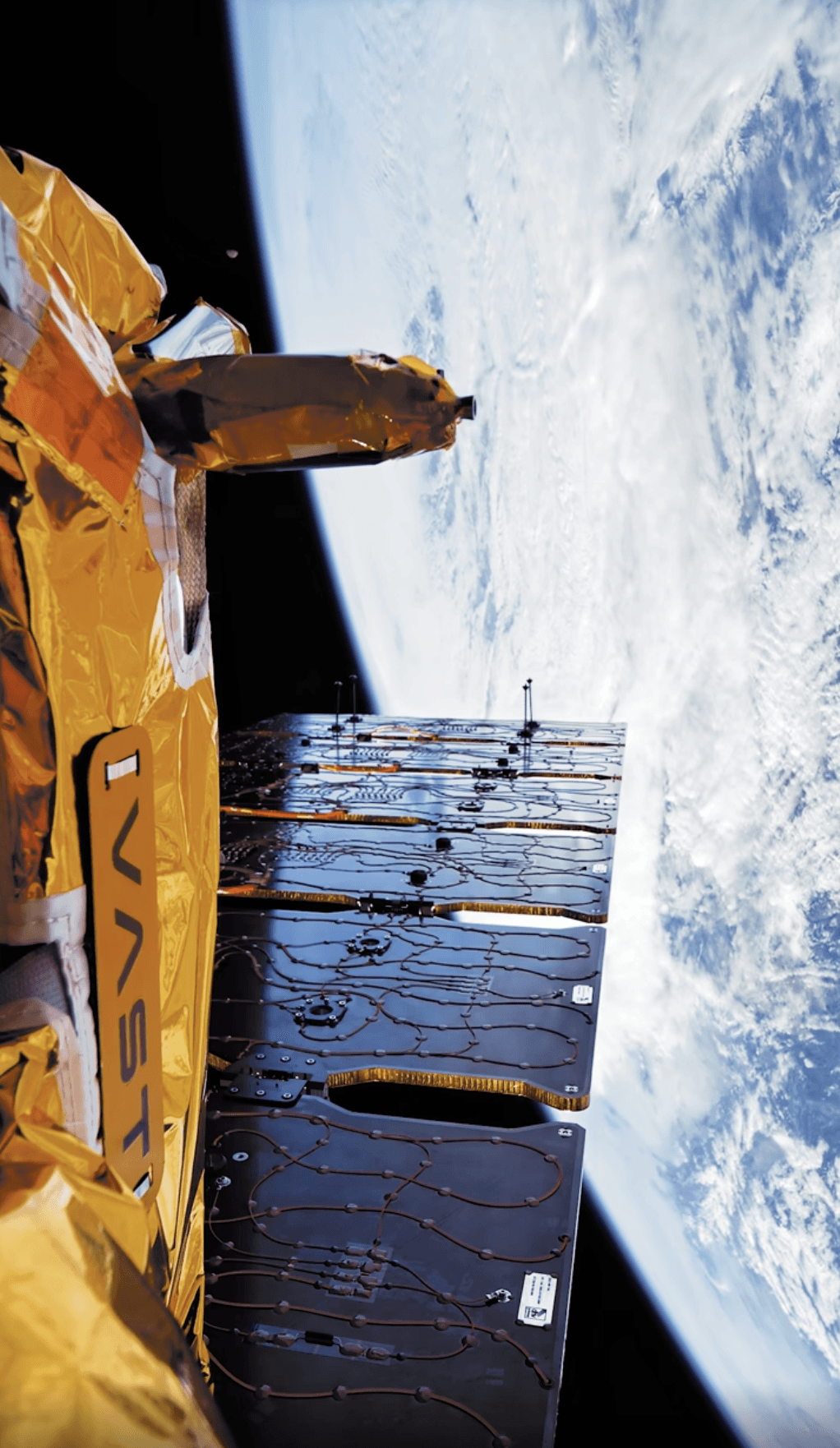 In-orbit footage captured by TRL11 cameras showing a gold foil-wrapped Vast spacecraft structure with Earth in the background