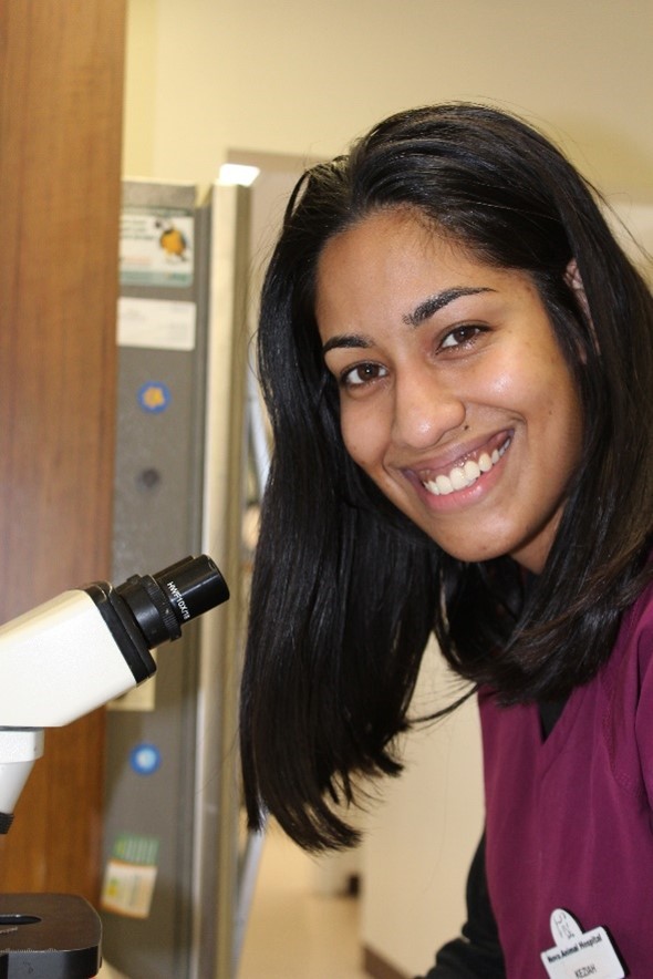 keziah posting with a microscope