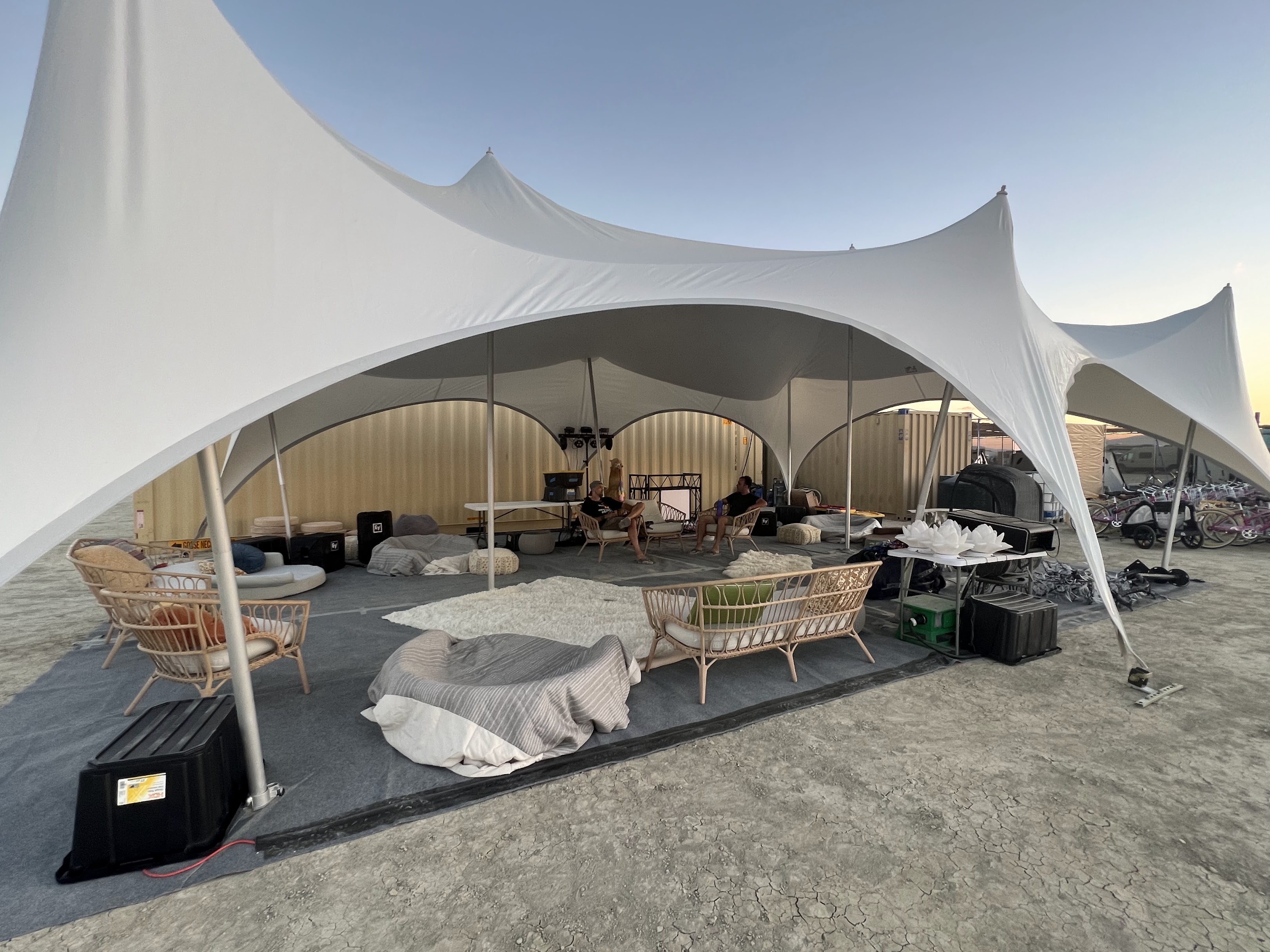 Shaded communal lounge area with seating and lighting at night