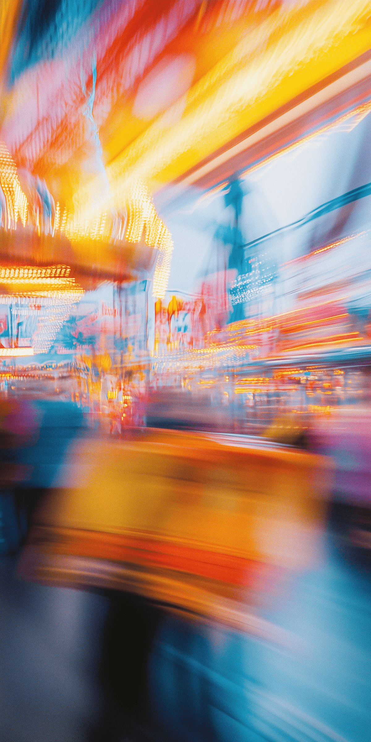 Abstract urban scene with vibrant streaks of orange, yellow and blue light.
