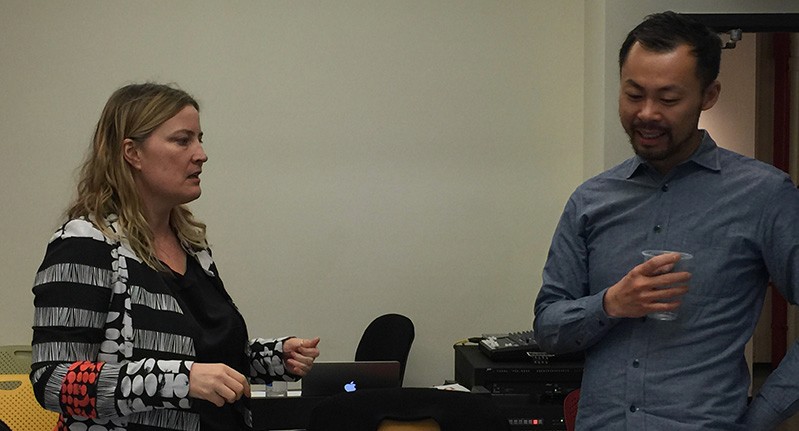 A photo of two people talking.