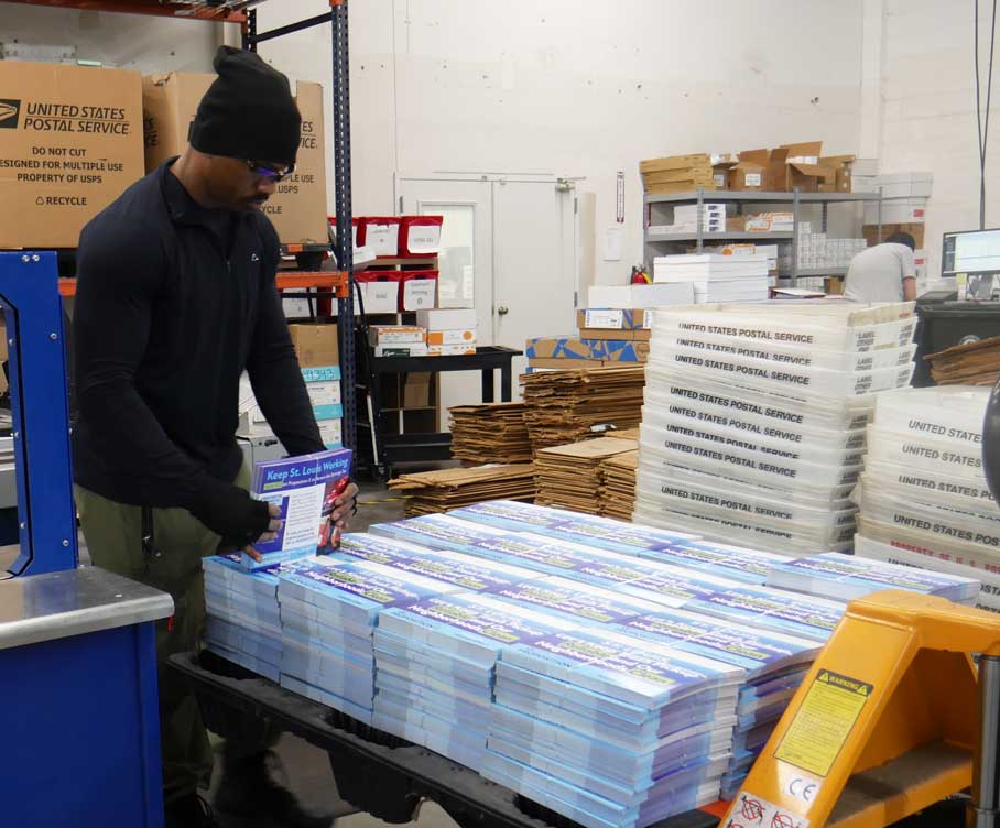 Employee inspecting and preparing a print job