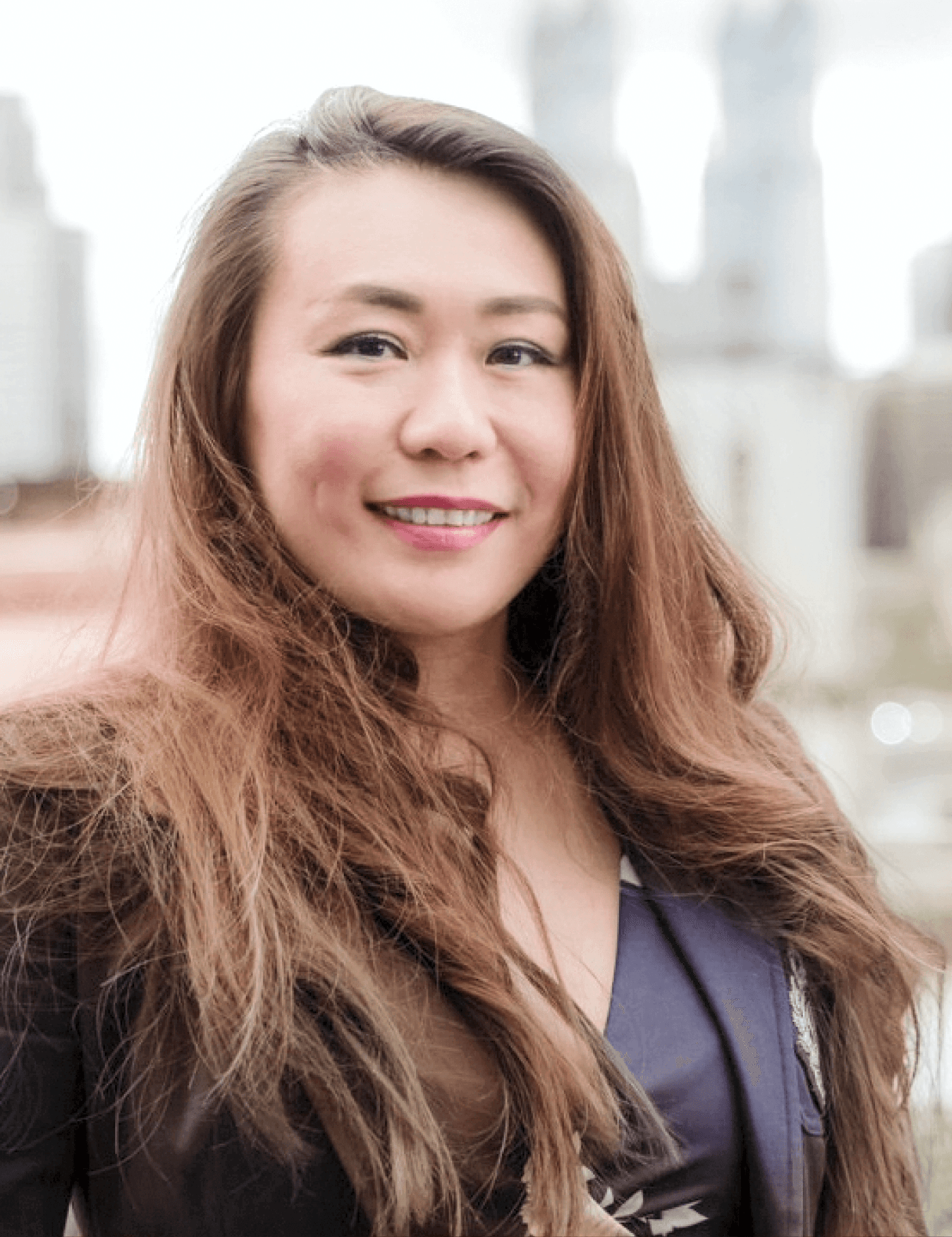 Head-and-shoulders portrait of the female co-founder, smiling at the camera.