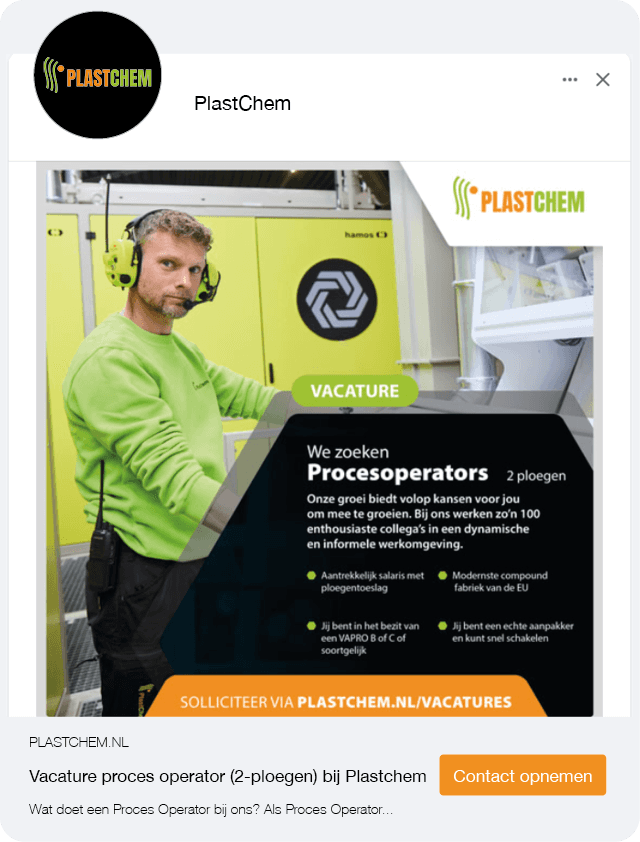 A dog sits on the grass, silhouetted against a beautiful sunset in the background.