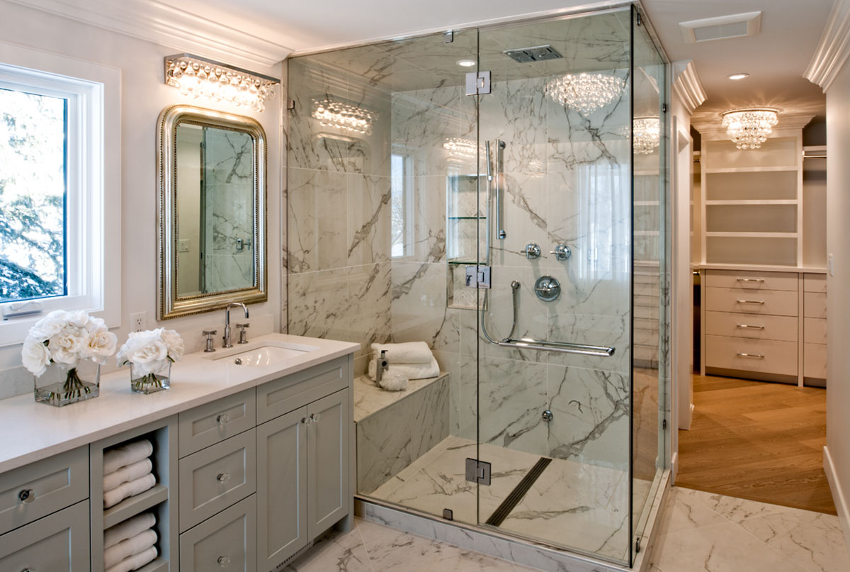 Image of Luxurious primary ensuite bathroom with marble shower, double vanity, and spacious walk-in closet by KHD Homes.