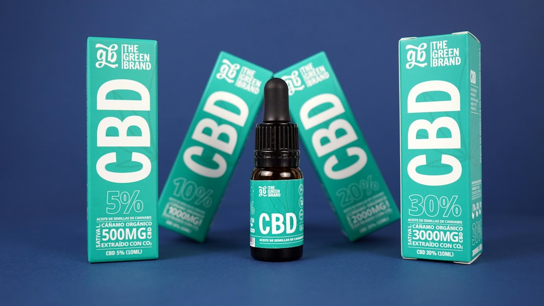 A bottle of cbd cbd is next to a box of cbd