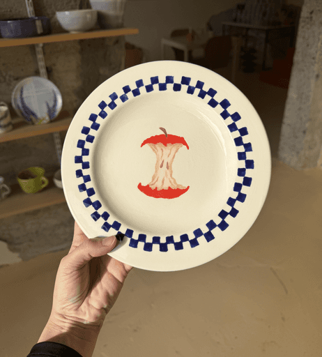 Full moon rising over a dark, silhouetted mountain ridge.