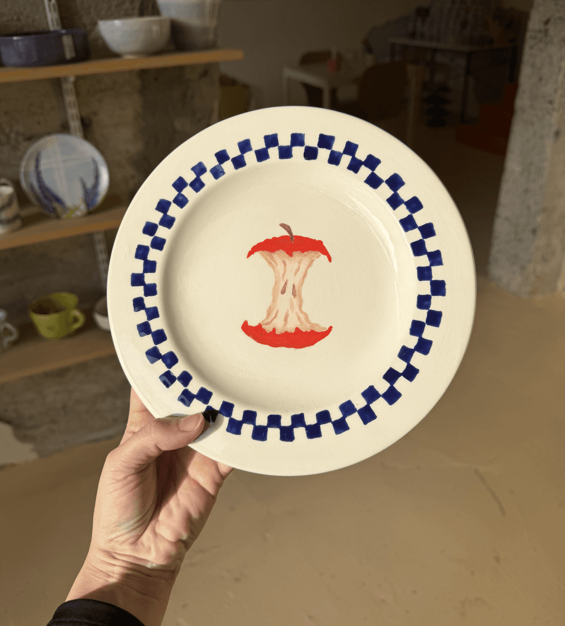 Full moon rising over a dark, silhouetted mountain ridge.