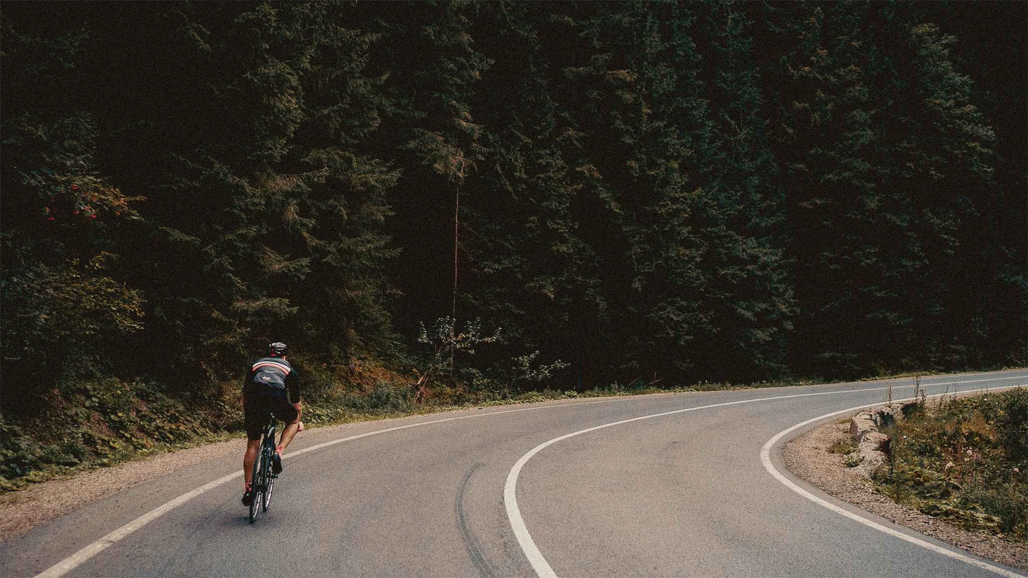 man riding on bicycle while standing on peak