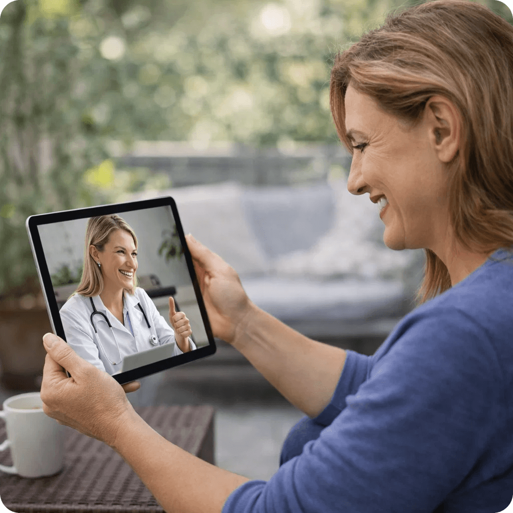 Woman smiling at her phone learning her nutrition therapy is covered by insurance