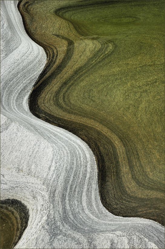 Abstract aerial view of layered earth and stone patterns forming natural flowing curves