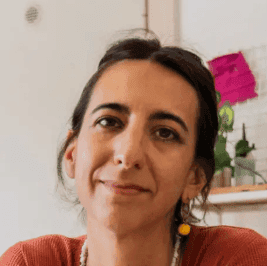smiling woman wearing white and black pinstriped collared top