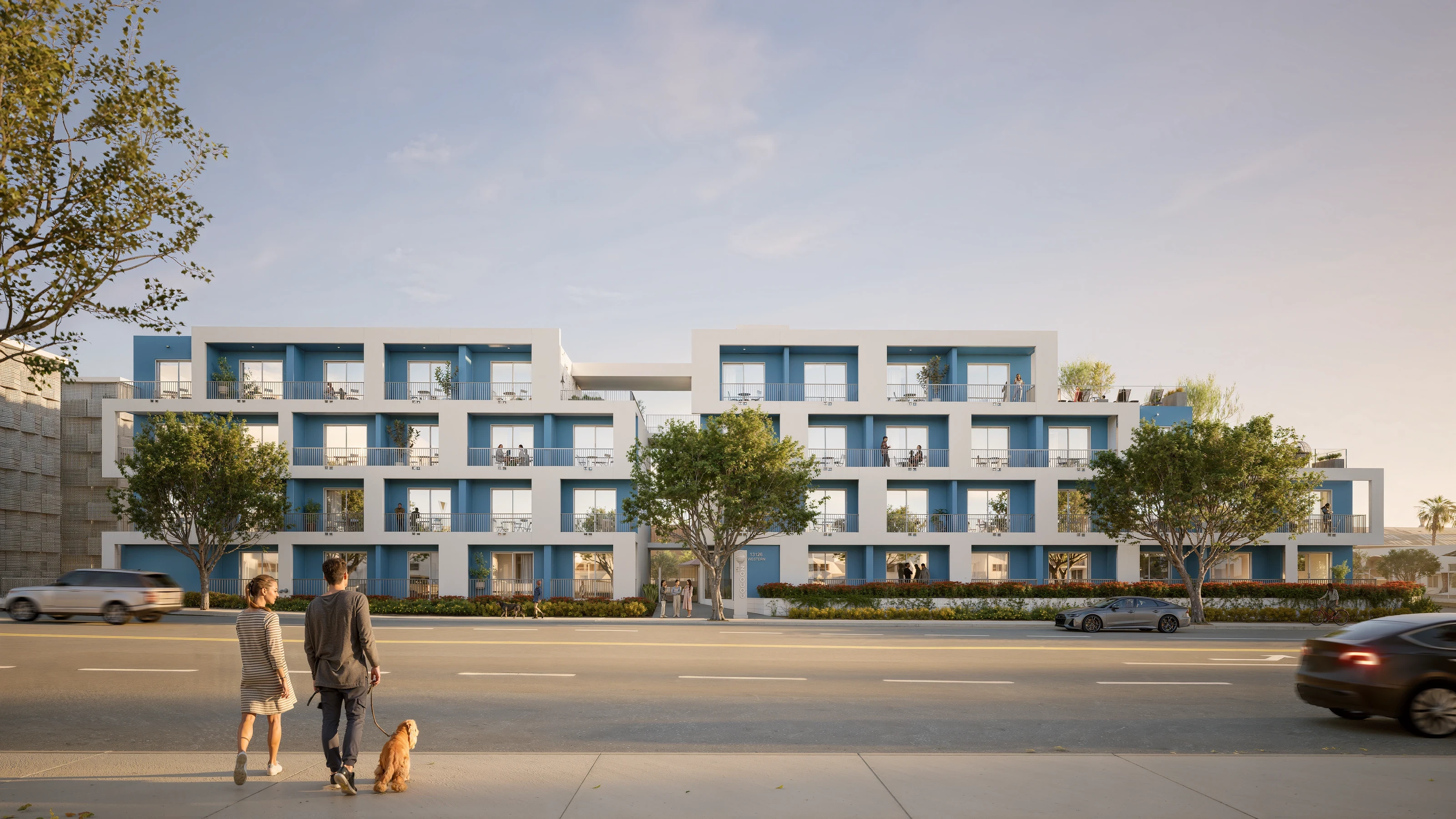 Couple with their dog standing in front of Cocoon 121, a modern residential building in Gardena, South Bay Los Angeles.