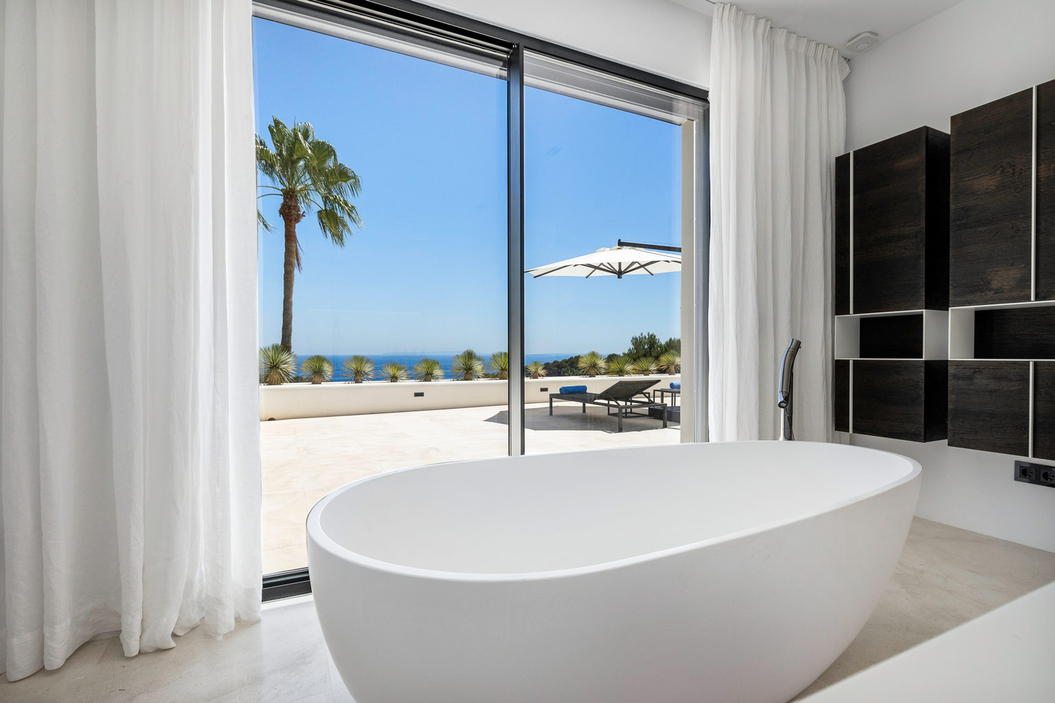 Master suite bathroom with sea view at luxury villa Ibiza, private estate property retreat.