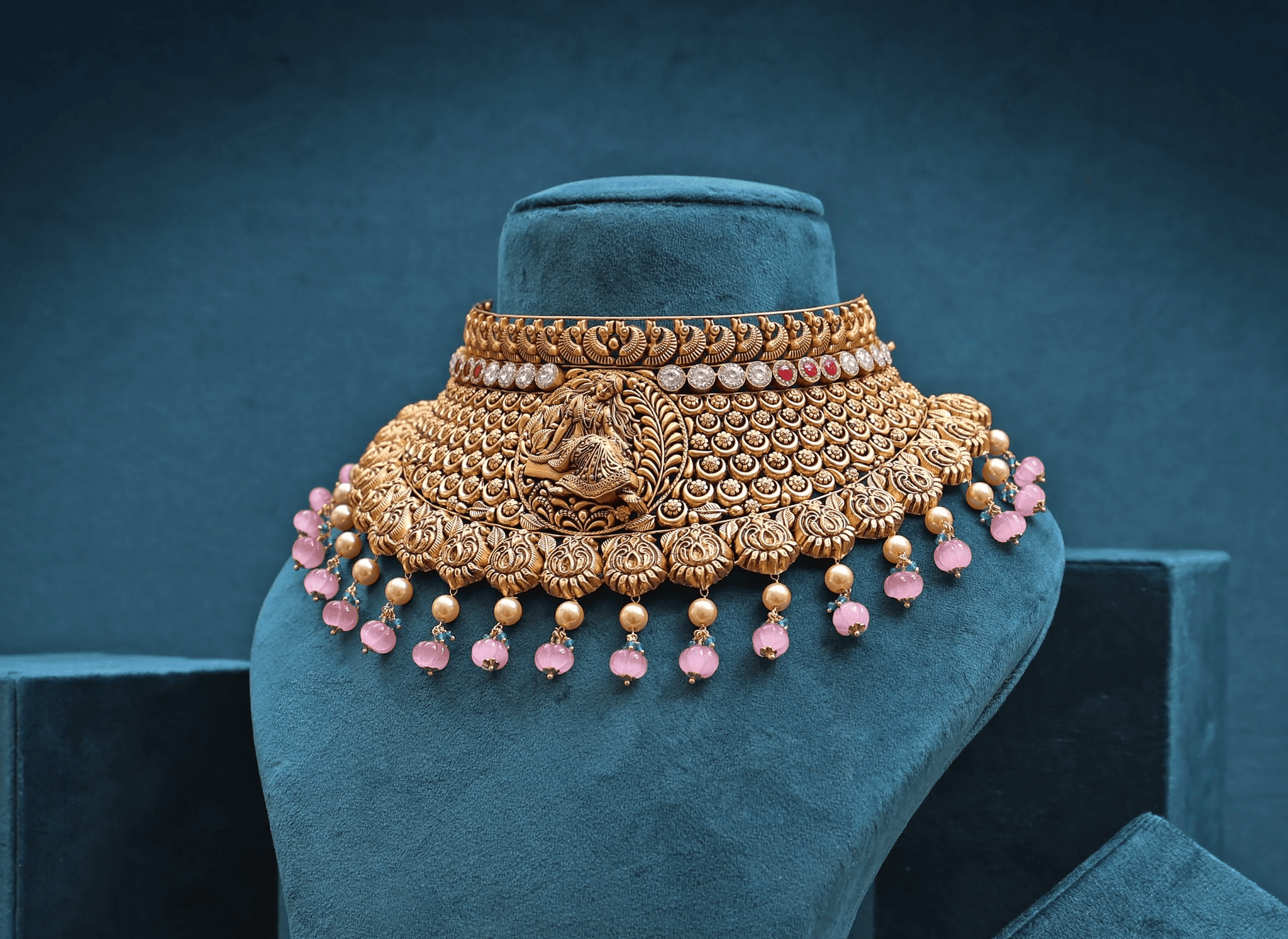 Traditional gold choker with ruby and pink gemstone drops by JORA Jewellers.