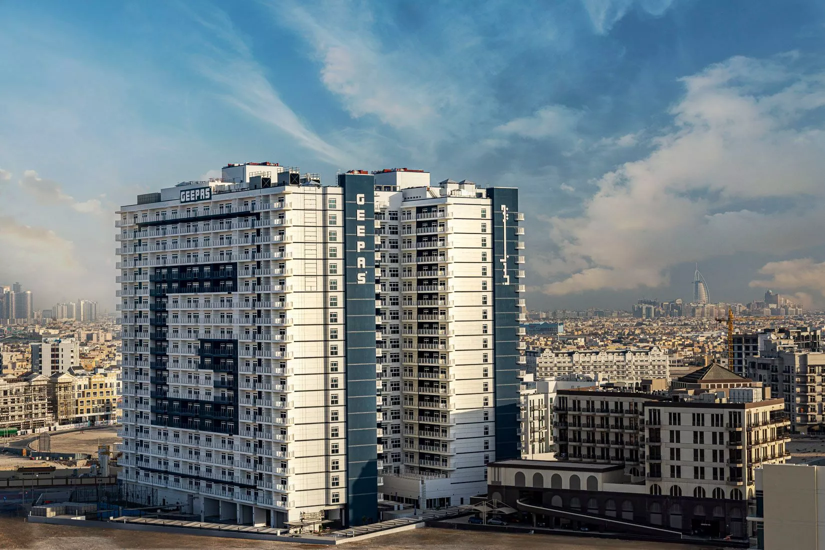 Wide cityscape view of the iconic Geepas Tower, a prime destination for real estate investment.
