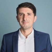 man standing in front of white concrete wall