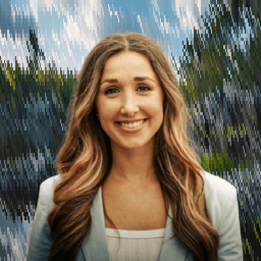 Professional portrait of a smiling woman against a natural outdoor background.