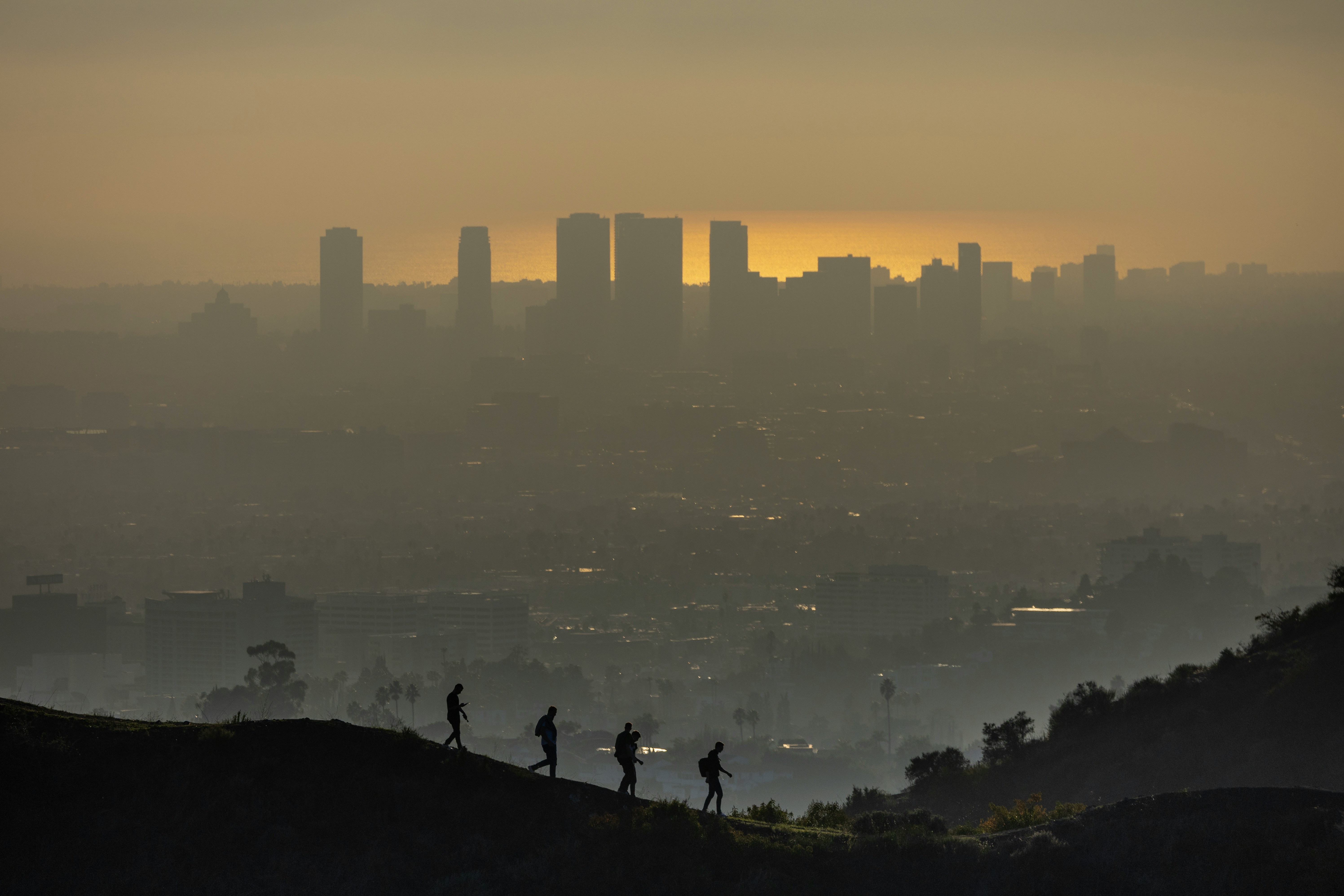 a group of people standing on top of a hill