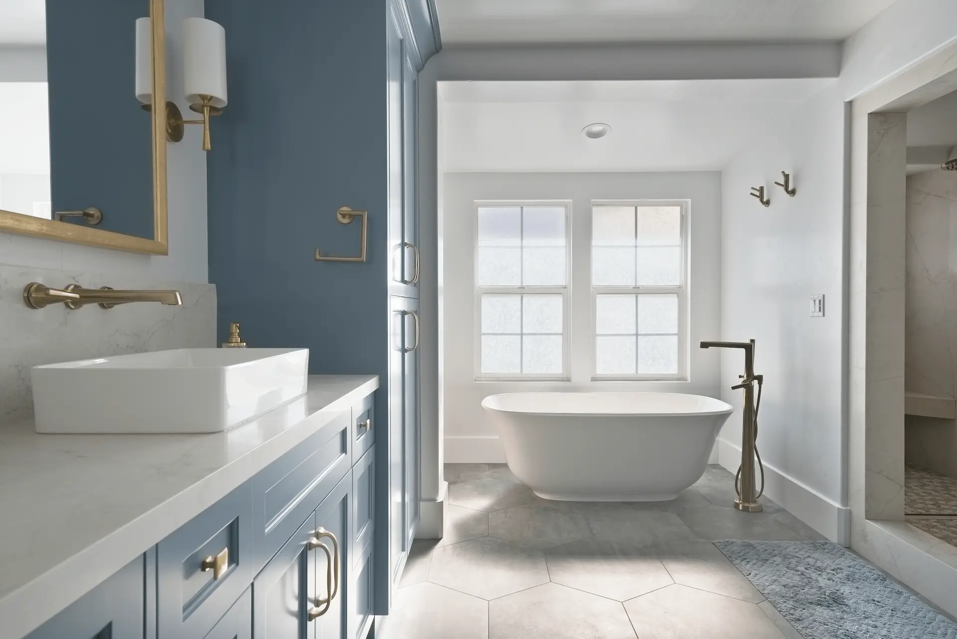 Wide view facing the free-standing tub in the primary bathroom, accentuating relaxation and contemporary style in the Ladera Ranch Remodel. Photo by Todd Huge.