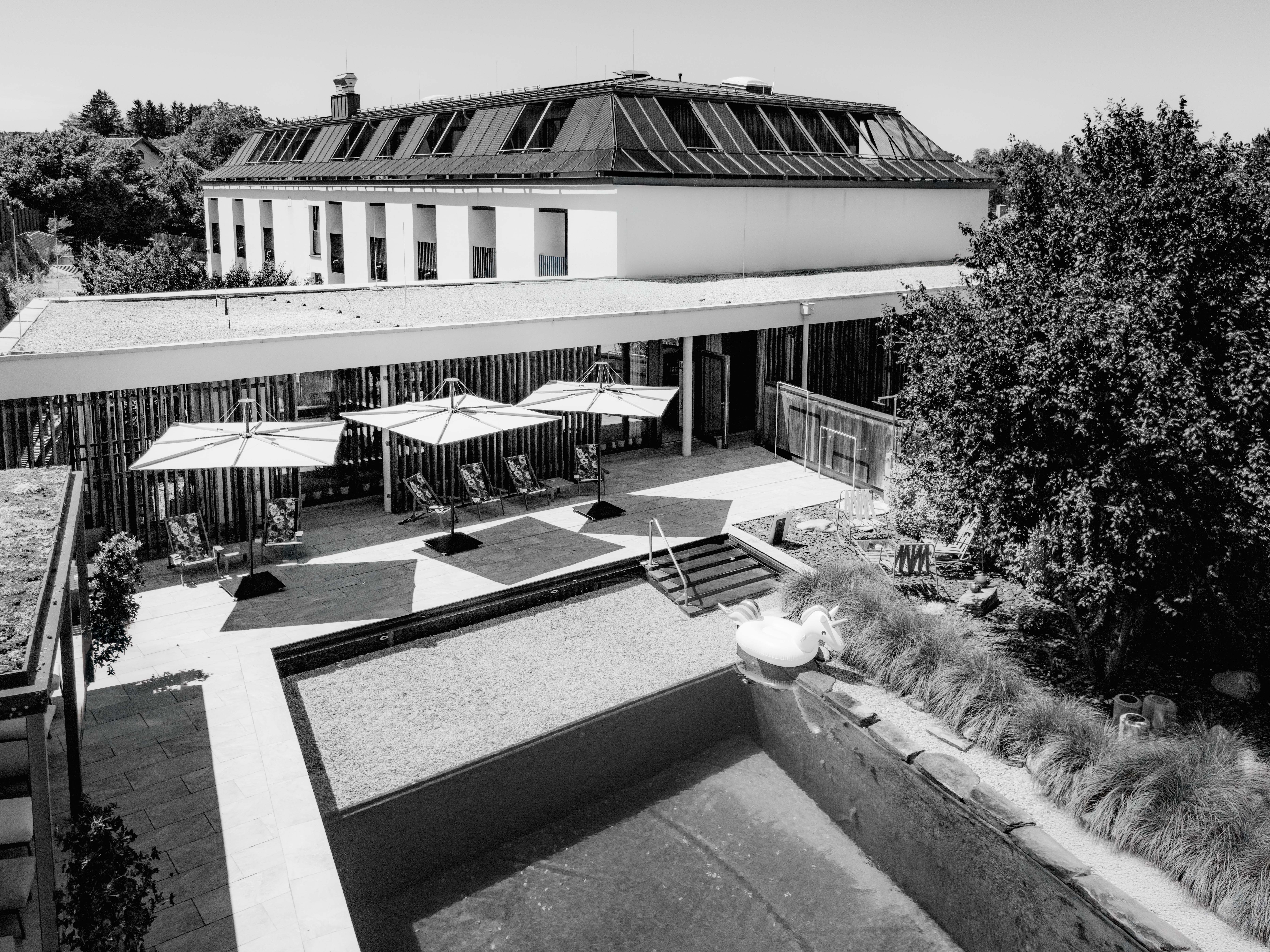 Two figures wrapped in blankets sit close together, with one person resting their head on the other's shoulder.